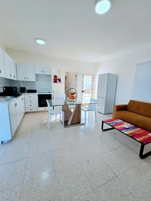 a kitchen and living room with a table and a couch at Greco 356 Apartment in Protaras