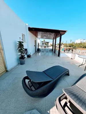 a view of a patio with chairs and a table at Greco 356 Apartment in Protaras