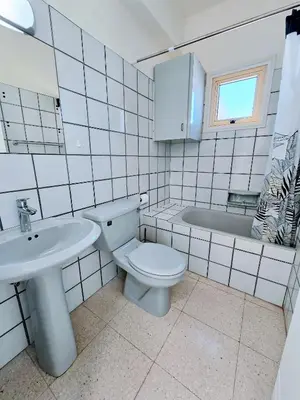 a bathroom with a toilet and a sink and a tub at Greco 356 Apartment in Protaras
