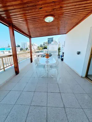 a patio with a table and chairs on a balcony at Greco 356 Apartment in Protaras