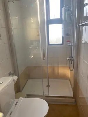 a shower with a glass door in a bathroom at A sea breeze villa in Pyla