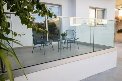 a glass house with two chairs and a table at Near City center 1 bedroom flat in Nicosia