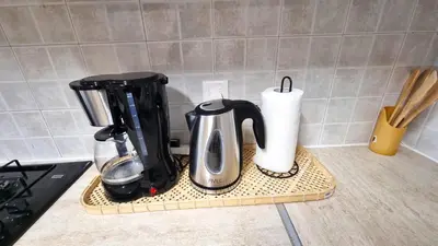 a kitchen counter with a coffee maker and paper towels at 5 Min Walk to Beach, Perfect Seaside Escape in Larnaka