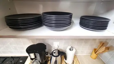 three stacks of plates on a shelf in a kitchen at 5 Min Walk to Beach, Perfect Seaside Escape in Larnaka