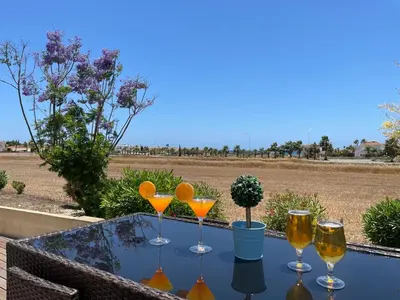 a table with four wine glasses on top of it at Maeva villa in Ayia Napa