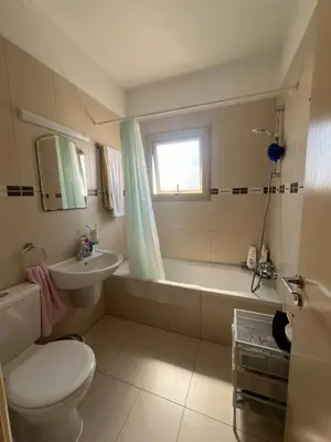 a bathroom with a toilet and a tub and a sink at Amour Et Citrons in Protaras