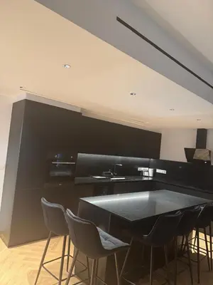 a dining room with a black table and chairs at Nicosia Delux in Nicosia