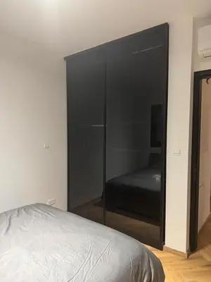 a bedroom with a large black closet with a bed at Nicosia Delux in Nicosia