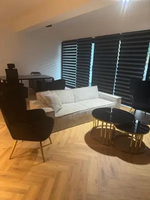 a living room with a white couch and a table at Nicosia Delux in Nicosia
