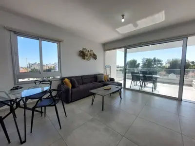 a living room with a couch and a table at Luxury 2 bedroom apartment 301 in Larnaka