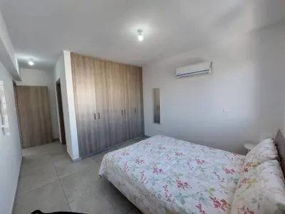 a bedroom with a bed and a cabinet in it at Luxury 2 bedroom apartment 301 in Larnaka