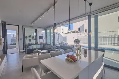 a kitchen and living room with a table and chairs at Protaras Almaria Villa ALM03 in Protaras