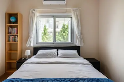 a bedroom with a bed and a window at Central, renovated, fully equipped, spacious 3BD in Strovolos