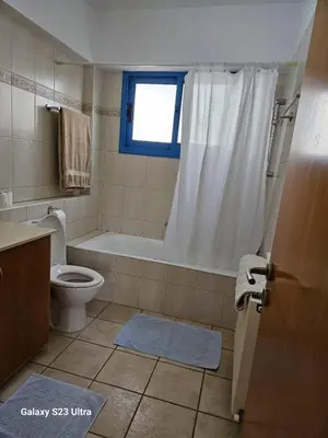 a bathroom with a tub and a toilet and a shower at De Angelo Villa in Pyla