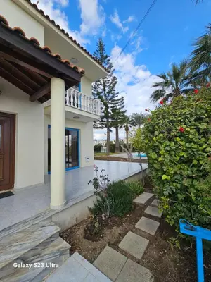 a house with a blue bench in front of it at De Angelo Villa in Pyla