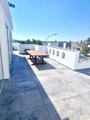 a picnic table on the roof of a building at Sea View Penthouse in Larnaka