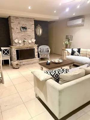 a living room with two couches and a fireplace at Sea View Penthouse in Larnaka