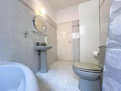 a white bathroom with a toilet and a sink at Albert's Apartment Center 101K in Larnaka