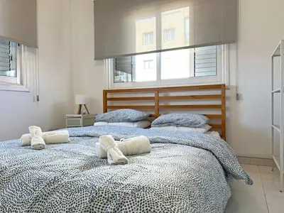 a bedroom with two beds with towels on them at Albert's Apartment Center 101K in Larnaka