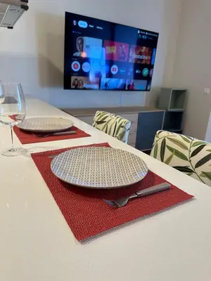 a table with a plate and a wine glass on it at Lux Hub Spot-Νear European Uni Engomi in Nicosia