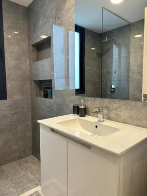 a bathroom with a white sink and a mirror at Lux Hub Spot-Νear European Uni Engomi in Nicosia