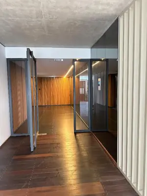 an empty hallway with glass doors in a building at Lux Hub Spot-Νear European Uni Engomi in Nicosia