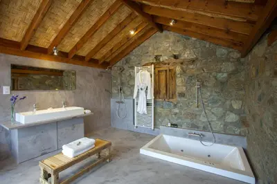 a large bathroom with a tub and a sink at Lyhnos in Askas
