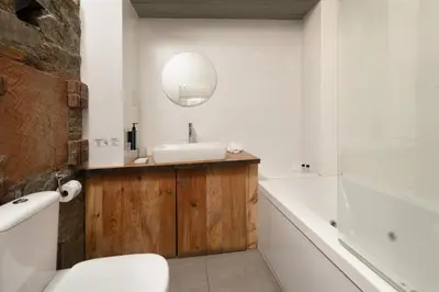 a bathroom with a sink and a tub and a mirror at Lyhnos in Askas