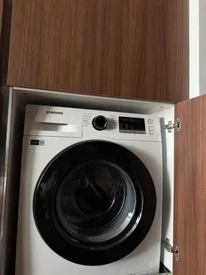 a washing machine is in a wooden cabinet at Grand sapphire resort Ötüken yeni iskele North Cyprus in İskele