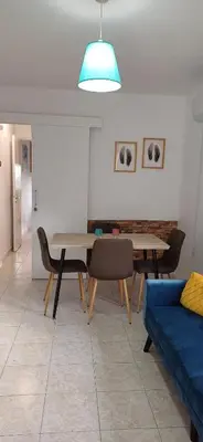 a living room with a table and a blue couch at Magic Maisonette 250m from the beach in Larnaka