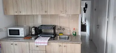 a kitchen counter with a sink and a microwave at Magic Maisonette 250m from the beach in Larnaka