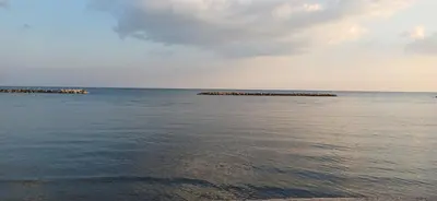 a view of the ocean with a rocky island in the water at Magic Maisonette 250m from the beach in Larnaka