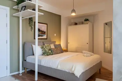 a bedroom with a bed with a white bed frame at Luna - Homely Studio W Balcony in Larnaca in Larnaka