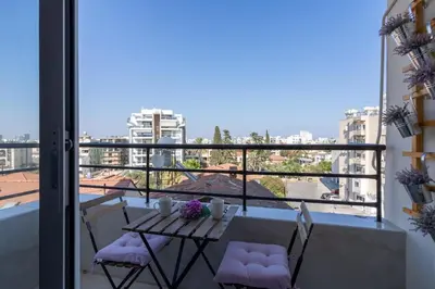 a balcony with a table and chairs and a view at Mosaic - 1 Bedroom Apartment in Larnaca in Larnaka