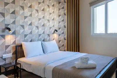 a bedroom with a bed with a towel on it at Mosaic - 1 Bedroom Apartment in Larnaca in Larnaka