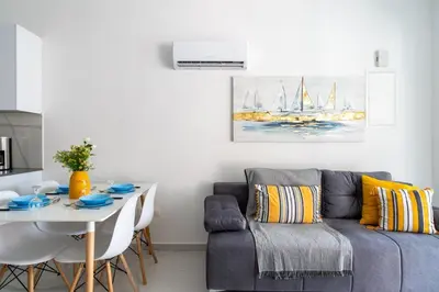 a living room with a couch and a table at Infinity - One-Bedroom Apt W Terrace in Larnaca in Larnaka