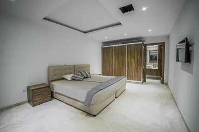 a bedroom with a bed and a television in it at Sunrise Dream Villa-Protaras in Protaras