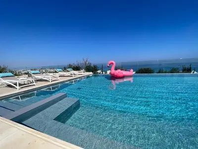 a swimming pool with a pink flamingo in the water at Sunrise Dream Villa-Protaras in Protaras