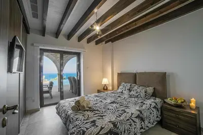 a bedroom with a bed and a view of the ocean at Sunrise Dream Villa-Protaras in Protaras