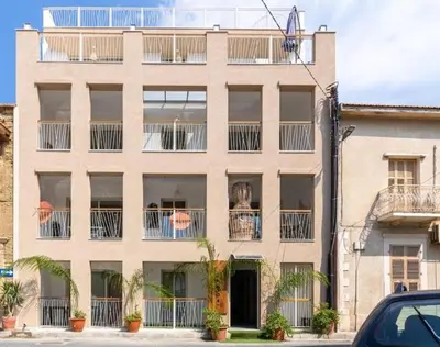an apartment building with plants on the balconies at Sunny Side Studio W Terrace in Larnaca in Larnaka
