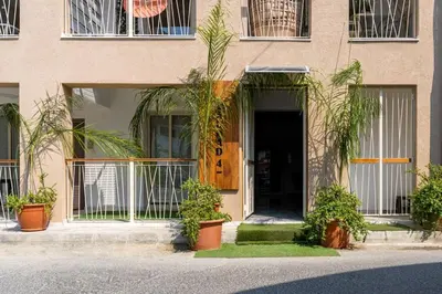 a building with potted plants in front of a door at Sunny Side Studio W Terrace in Larnaca in Larnaka