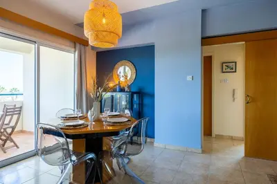 a dining room with a wooden table and chairs at Bayview 2-BR Apartment W Terrace in Larnaca in Larnaka