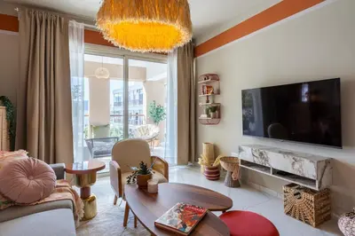 a living room with a flat screen tv on the wall at Sundrop - 1-Bedroom Apt W Terrace in Larnaca in Larnaka