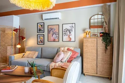 a living room with a couch and a table at Sundrop - 1-Bedroom Apt W Terrace in Larnaca in Larnaka