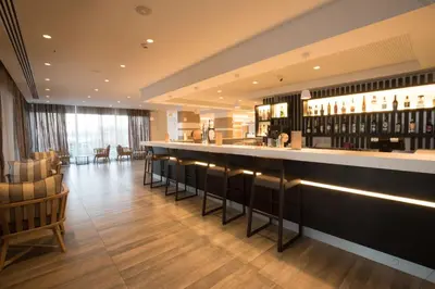 a bar in a restaurant with chairs and tables at Evalena Beach Hotel in Protaras