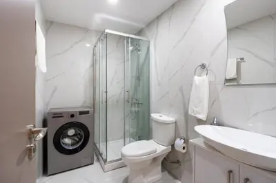 a bathroom with a toilet and a sink and a shower at Sunstone - Cozy Studio W Terrace in Larnaca in Larnaka