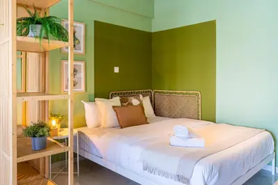 a bed in a room with green walls at Sunstone - Cozy Studio W Terrace in Larnaca in Larnaka