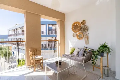 a living room with a couch and a table at Sunstone - Cozy Studio W Terrace in Larnaca in Larnaka
