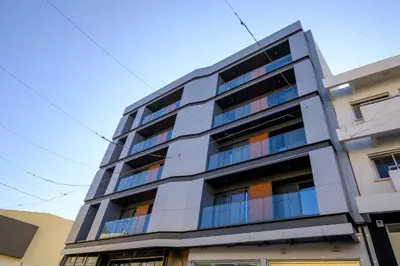 an apartment building with balconies on the side of it at Maestro City Apartments in Larnaka