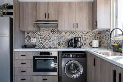 a kitchen with a stove and a dishwasher at Liric - 3 Bedroom Apt W Balcony in Larnaca in Larnaka